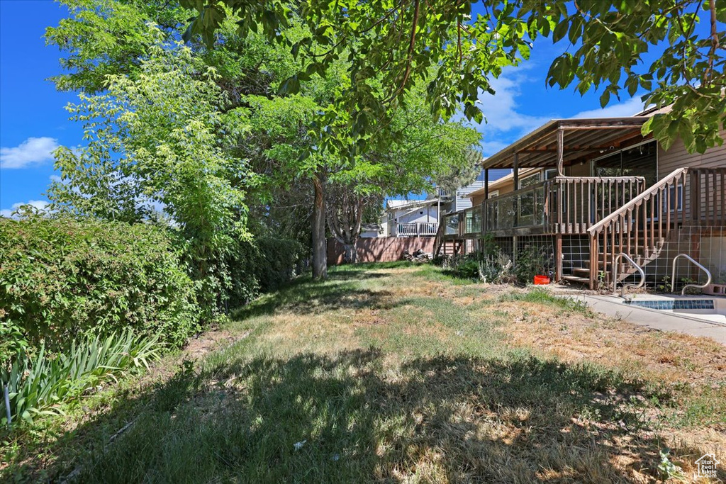 View of yard with a wooden deck