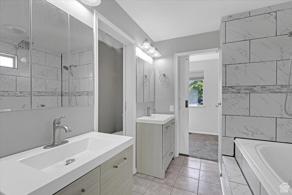 Bathroom with double vanity and tile patterned floors