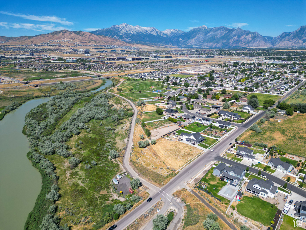 Birds eye view of property with a water and mountain view