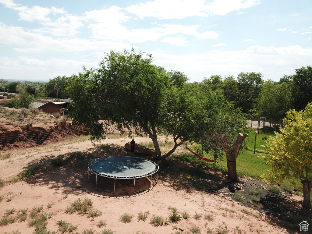 View of yard featuring a trampoline