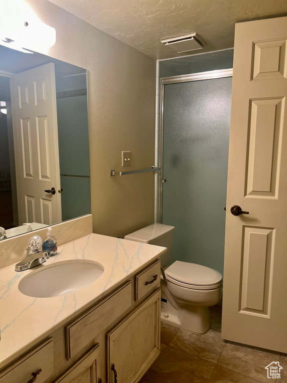 Bathroom with tile patterned floors, vanity, and toilet