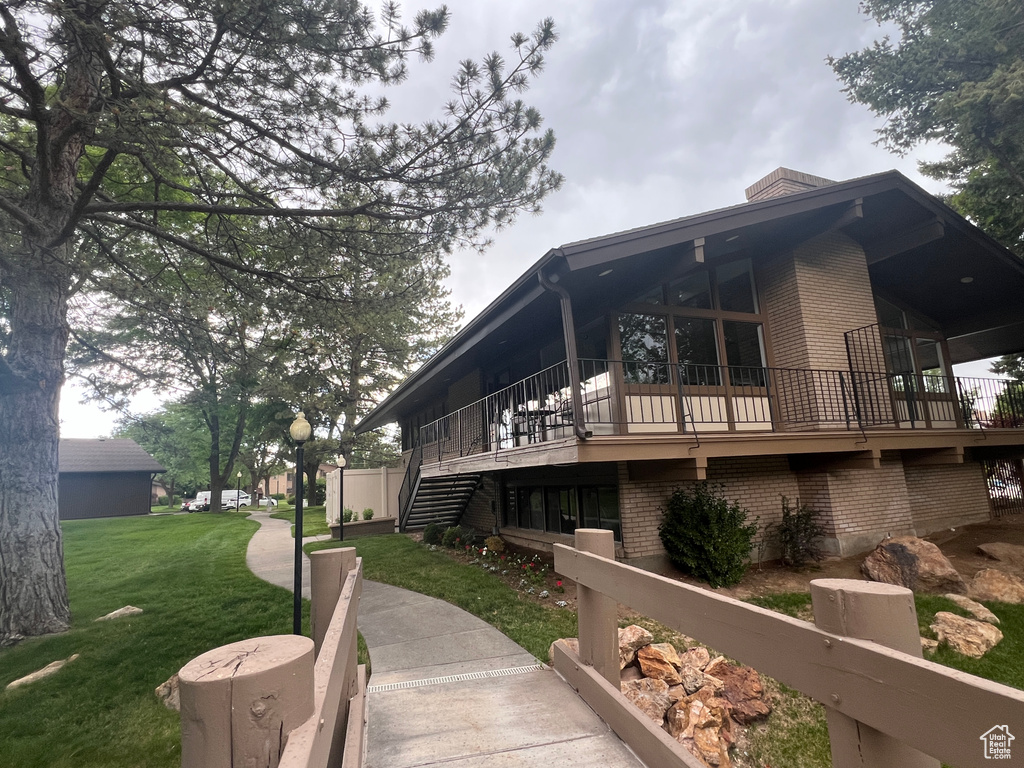 View of side of home with a lawn