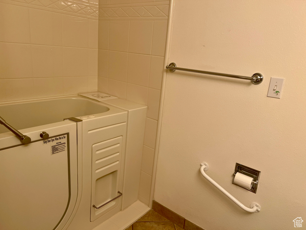 Bathroom featuring tile patterned flooring and a bathing tub