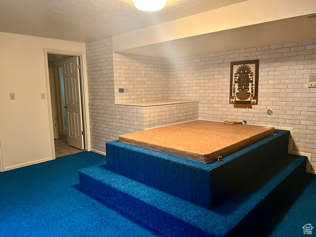 Interior space featuring carpet flooring and a textured ceiling