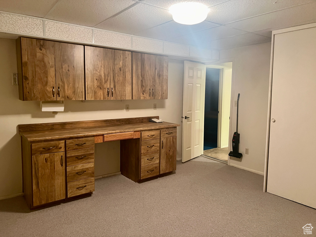 Unfurnished office featuring light colored carpet and a paneled ceiling