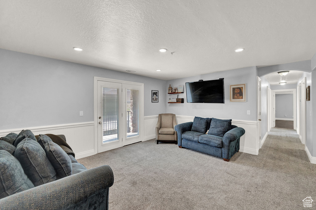 Living room featuring carpet floors and a textured ceiling