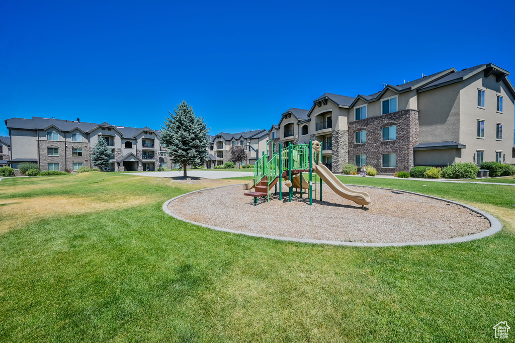 View of playground featuring a lawn