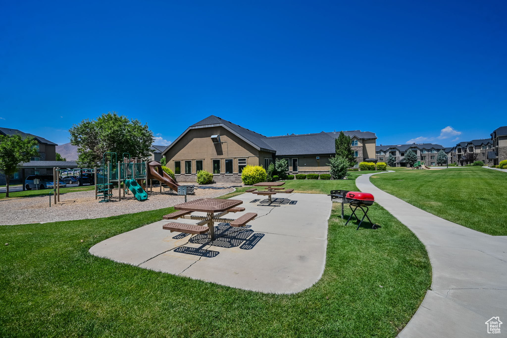 View of property's community featuring a yard and a playground