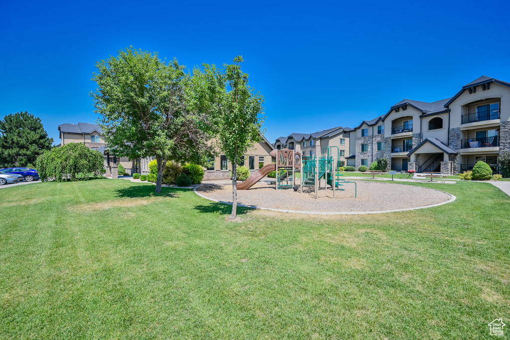 View of jungle gym with a lawn