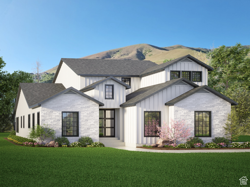 View of front of house with a front lawn and a mountain view