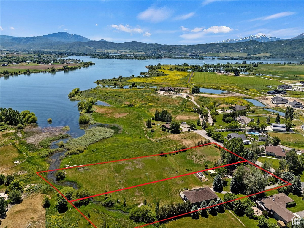 Birds eye view of property featuring a water and mountain view