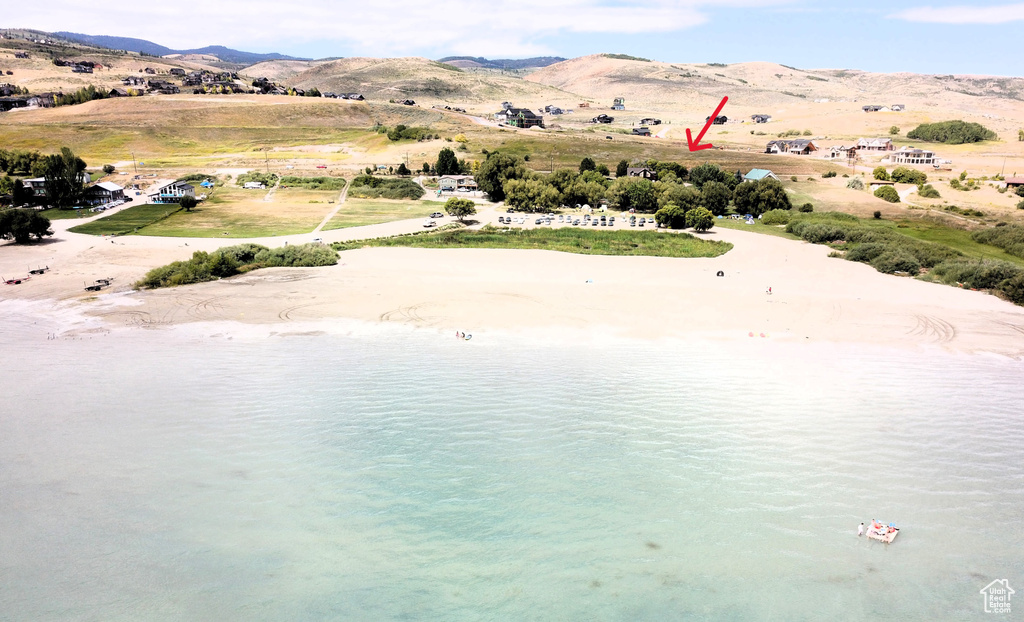 Drone / aerial view featuring a water and mountain view