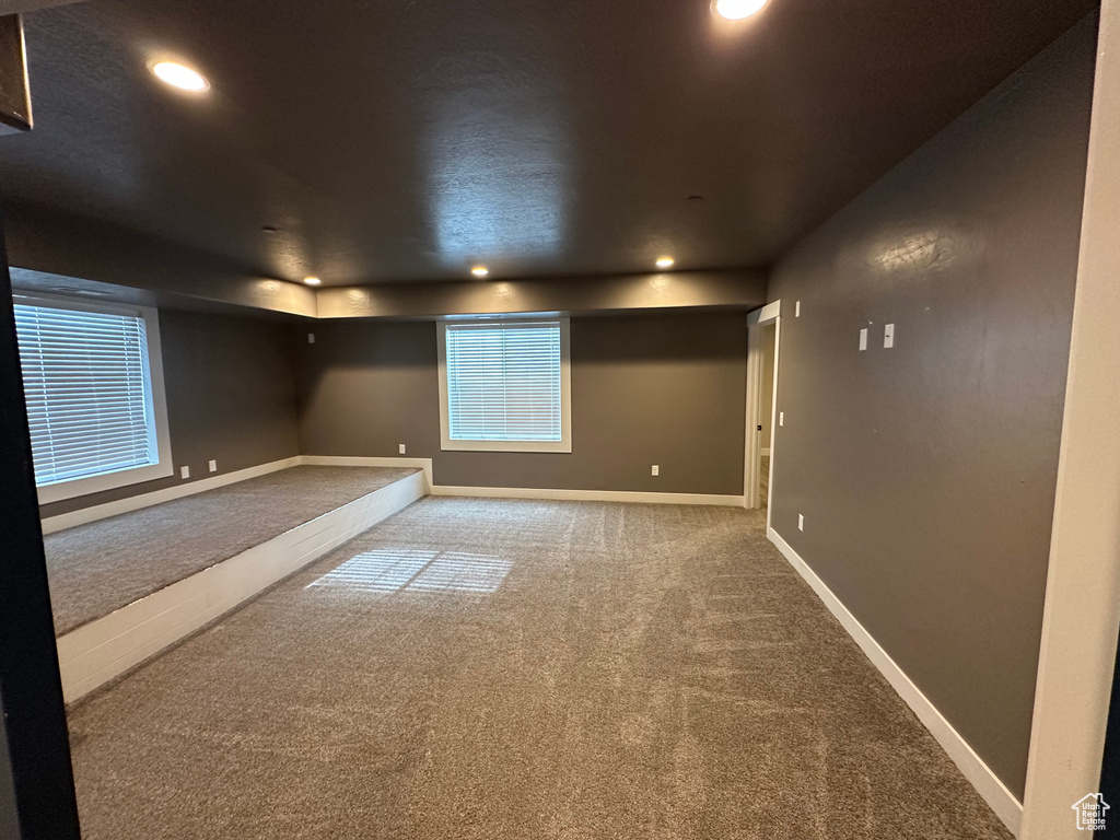 Carpeted empty room featuring baseboards and recessed lighting