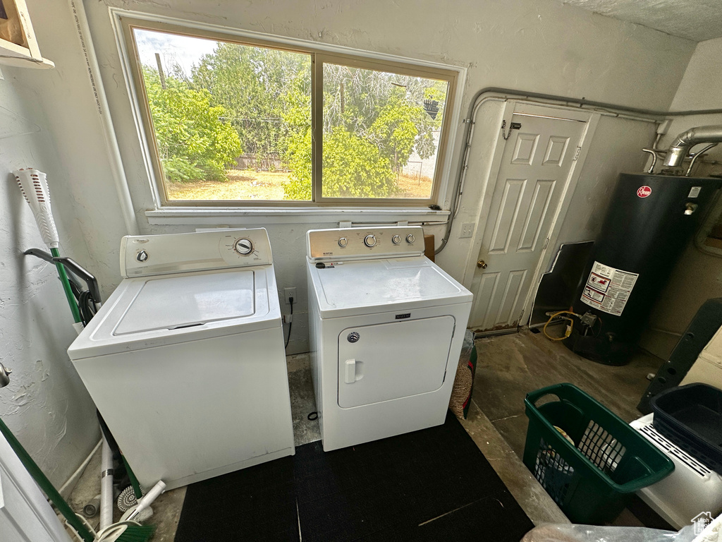 Washroom with water heater and washer and dryer