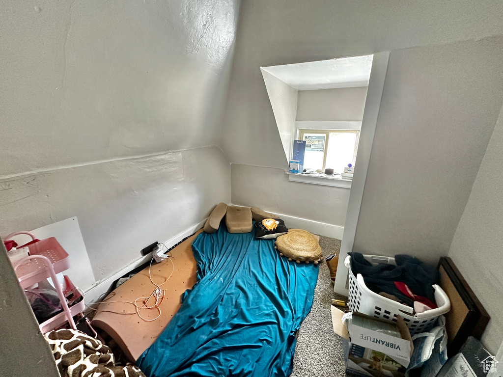 Interior space featuring vaulted ceiling and carpet