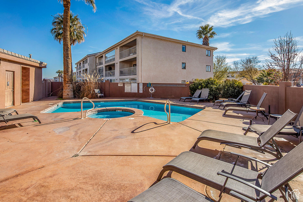 View of pool featuring a patio area and a community hot tub