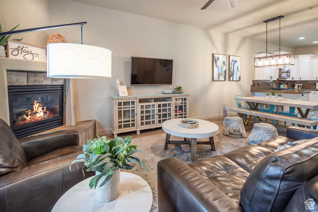 Living room with ceiling fan and wood-type flooring