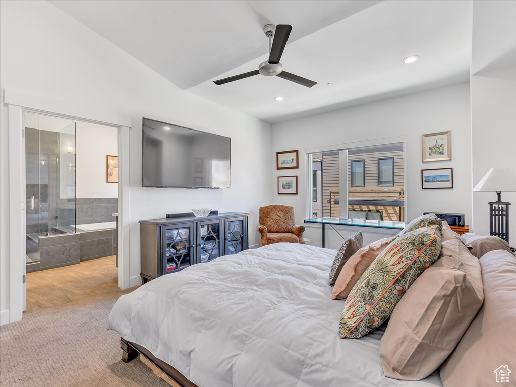 Bedroom with ensuite bathroom, ceiling fan, and carpet flooring