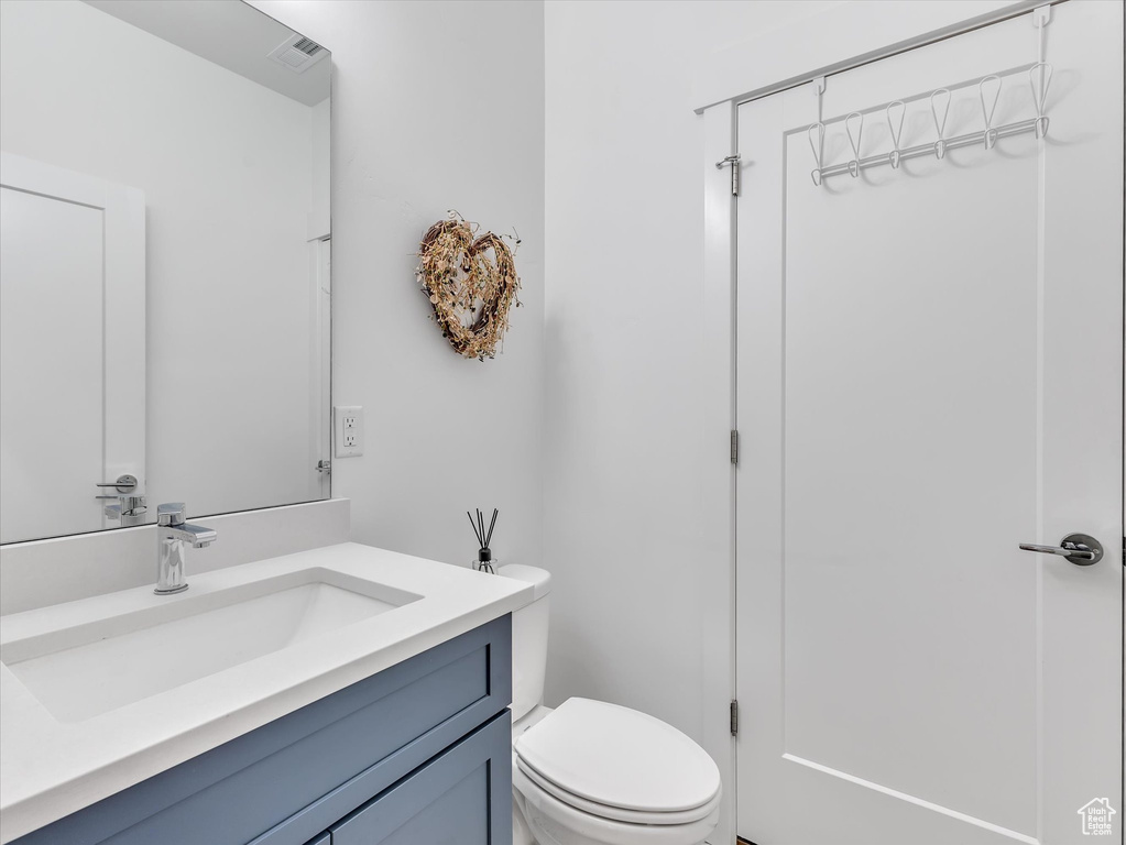 Bathroom featuring vanity and toilet