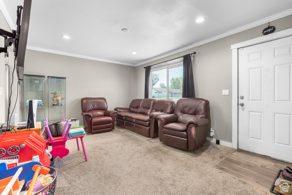 Living room featuring hardwood / wood-style floors and ornamental molding