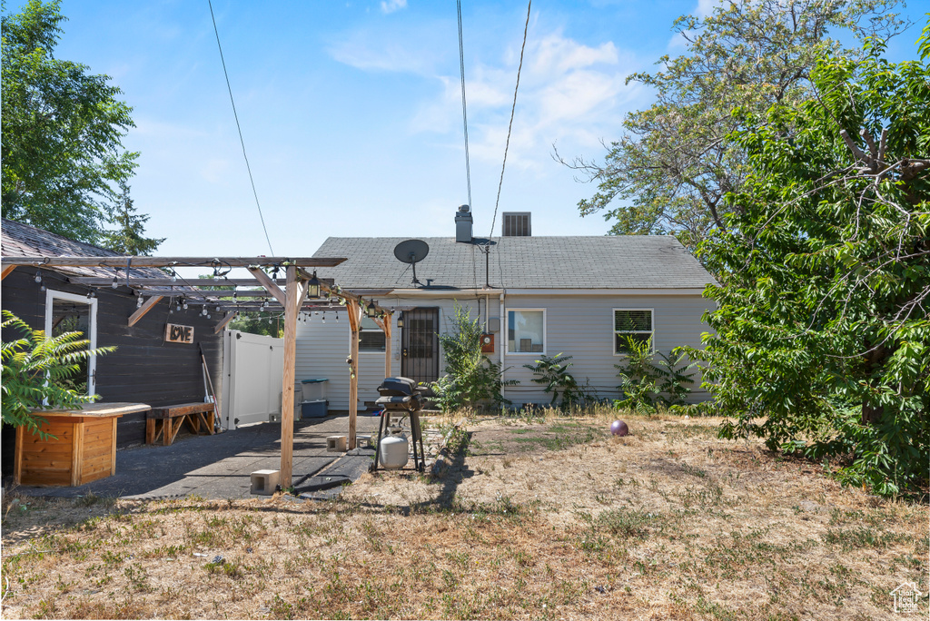 Rear view of house featuring a pergola