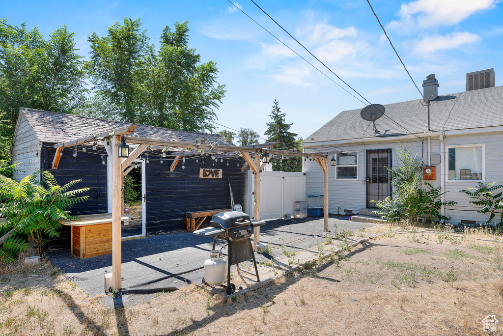 Rear view of property featuring a patio area