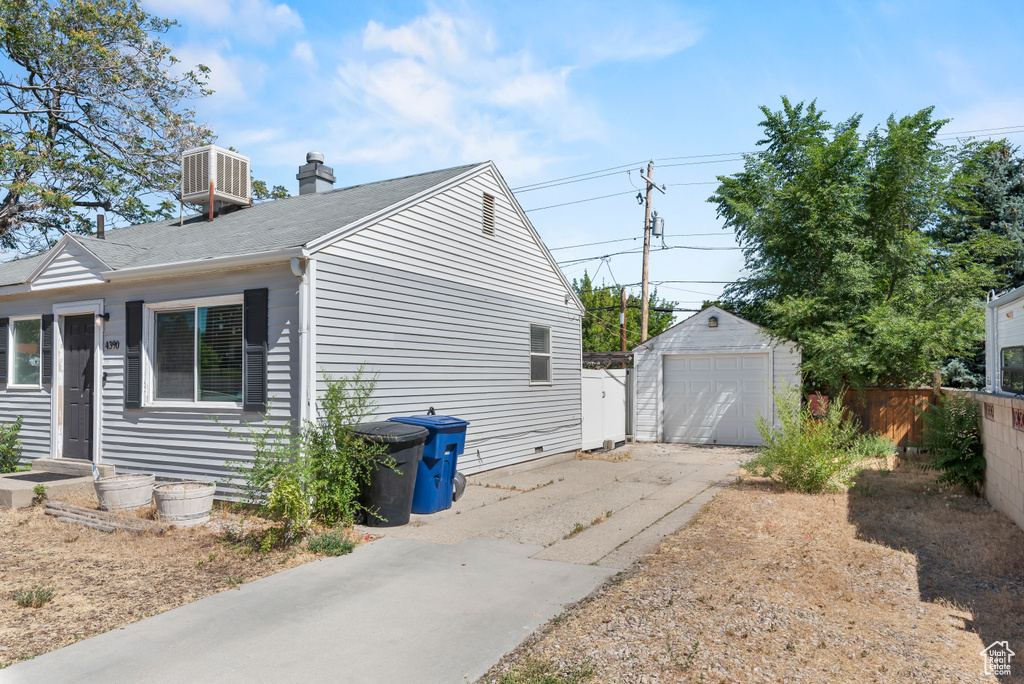 View of home's exterior with a garage and an outdoor structure