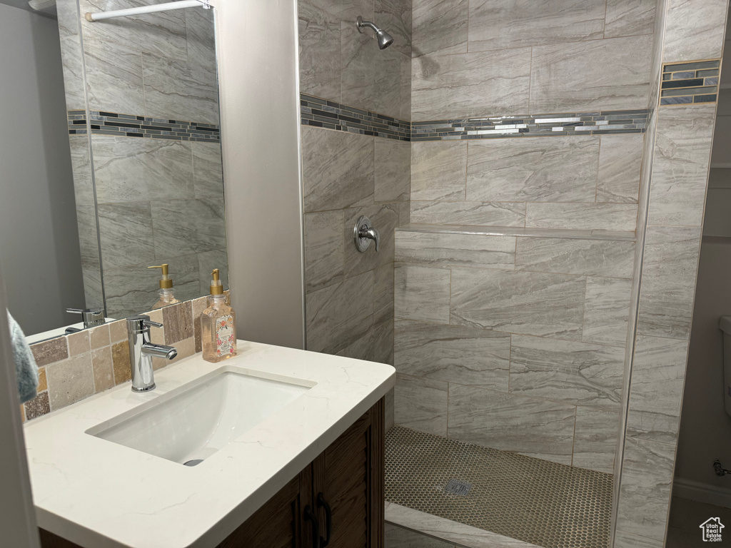 Bathroom with vanity and a tile shower