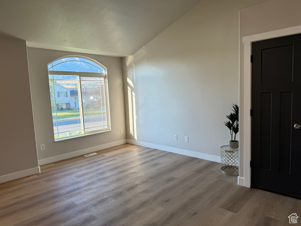 Empty room featuring hardwood / wood-style flooring