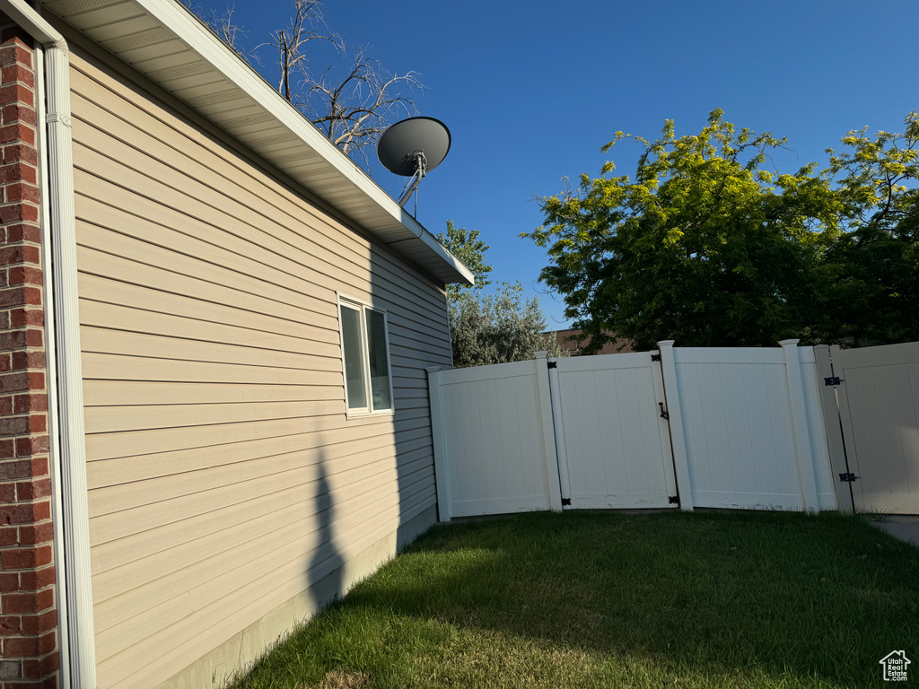 View of side of home with a yard