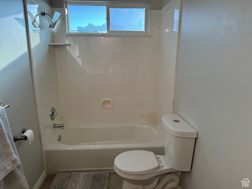 Bathroom featuring toilet and  shower combination