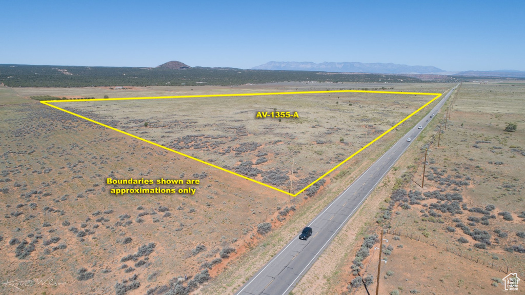 Birds eye view of property with a mountain view and a rural view