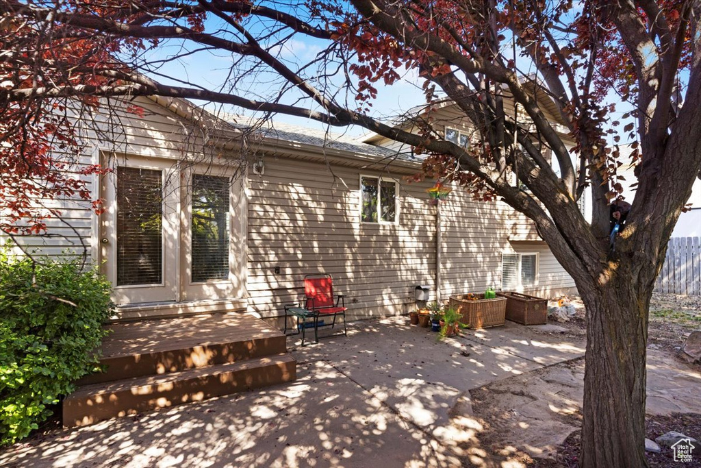 Back of property featuring a patio area and a wooden deck