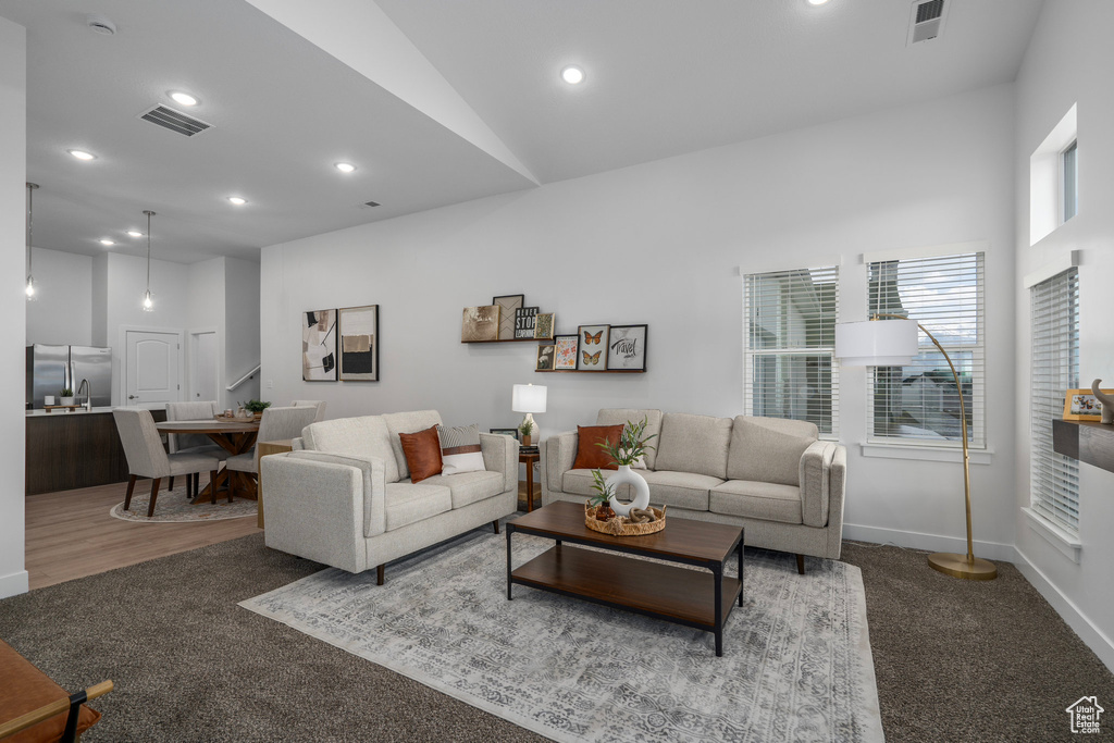 Living room with vaulted ceiling and carpet