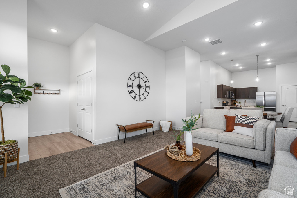 Living room featuring light hardwood / wood-style flooring and high vaulted ceiling