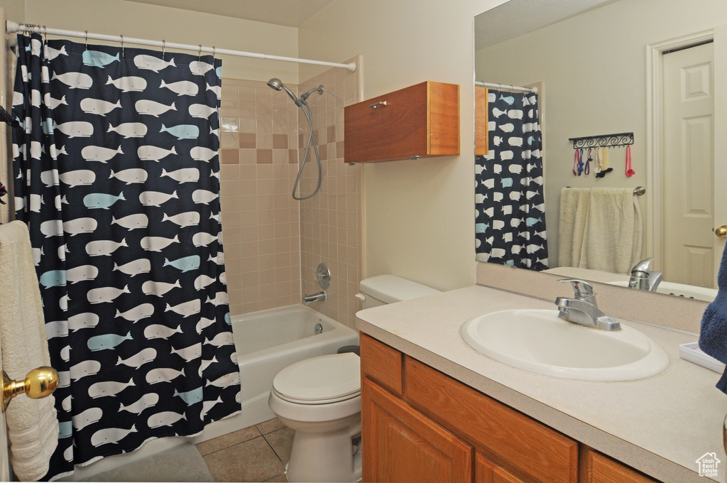 Full bathroom featuring tile patterned floors, vanity, shower / bathtub combination with curtain, and toilet