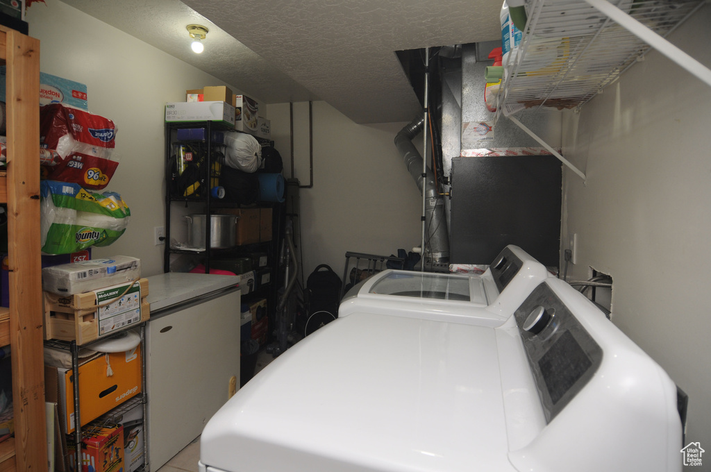 Laundry room with washer and clothes dryer