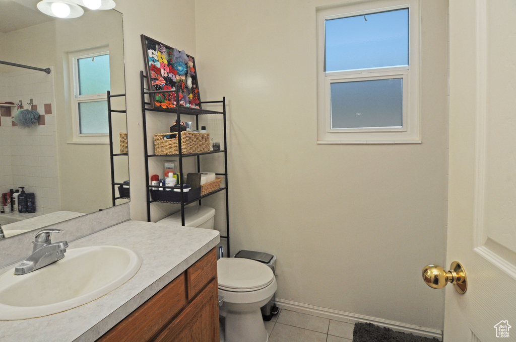 Bathroom featuring tile patterned flooring, toilet, and vanity