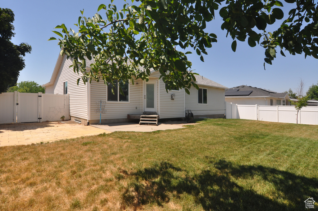 Back of property with a patio area and a yard