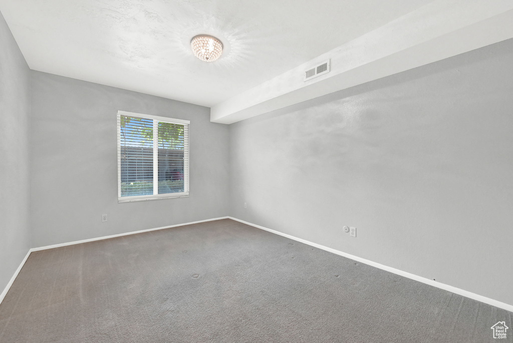 Empty room with carpet flooring