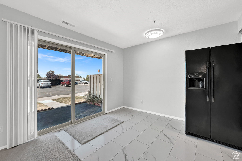 Interior space with light tile patterned flooring