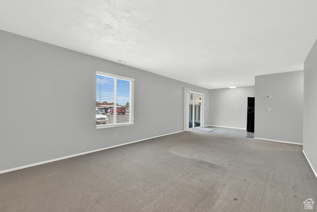 Unfurnished living room featuring carpet