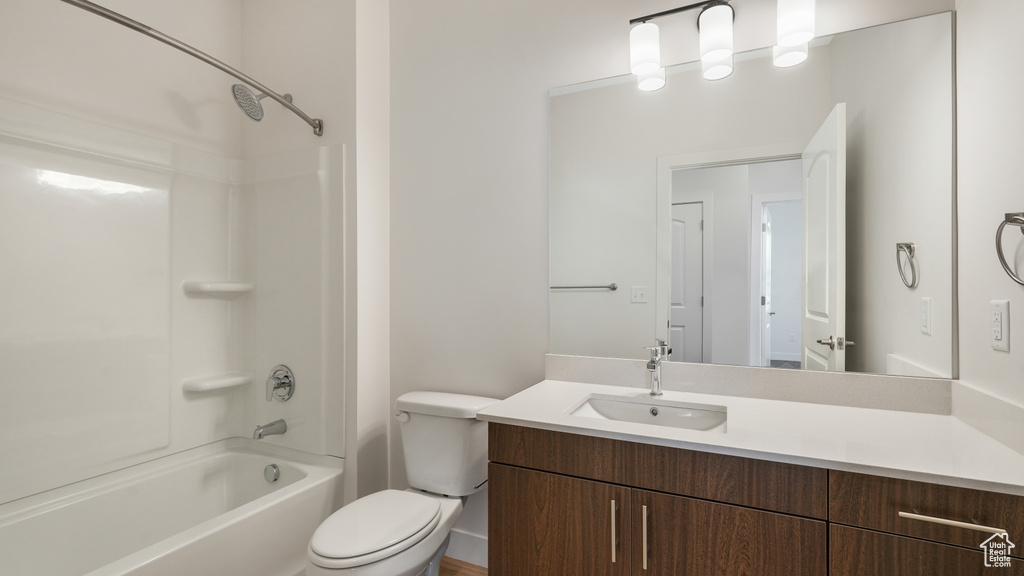 Full bathroom featuring vanity, toilet, and washtub / shower combination