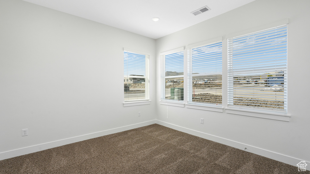 Spare room featuring carpet