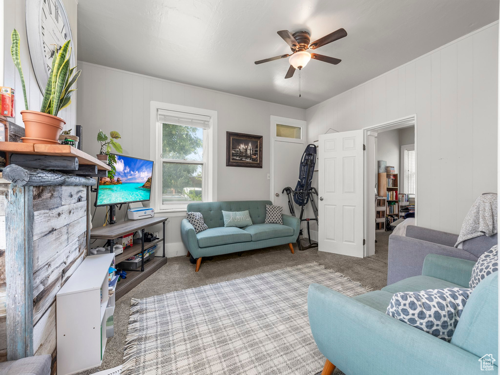 Living room featuring carpet floors and ceiling fan