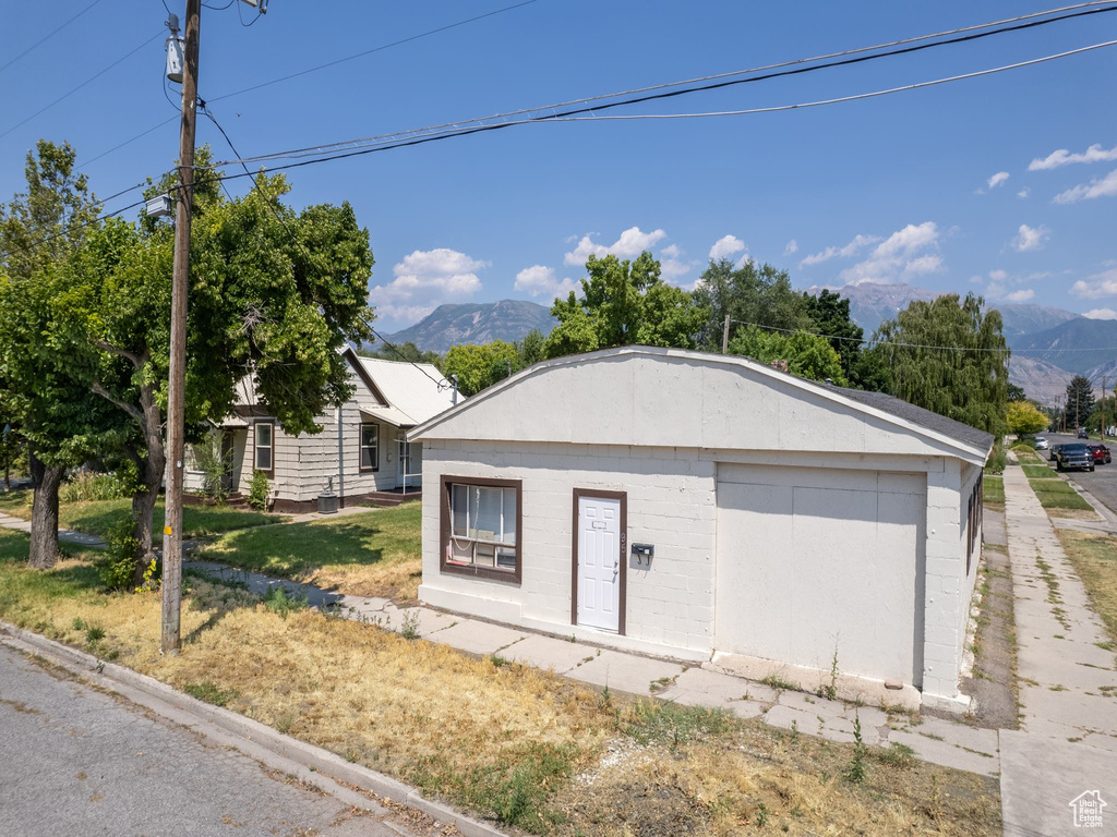 Exterior space with a mountain view and a lawn