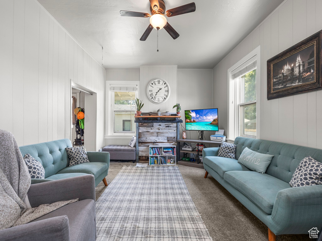 Living room featuring carpet floors and ceiling fan