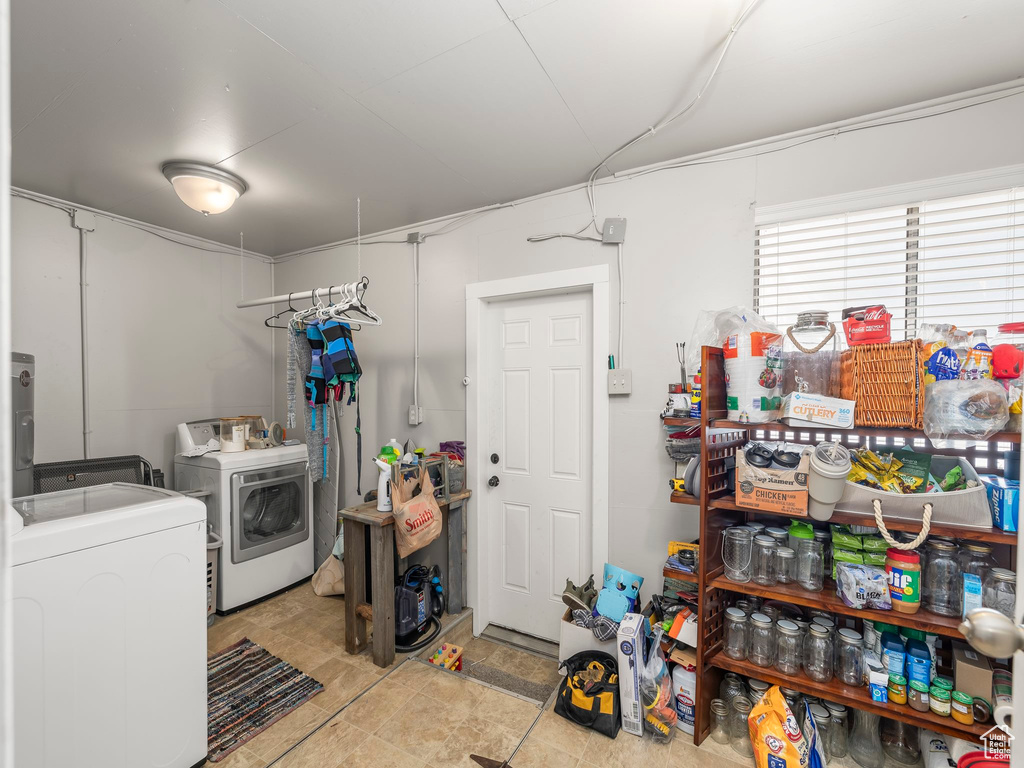 Laundry room featuring washing machine and dryer and light tile patterned floors