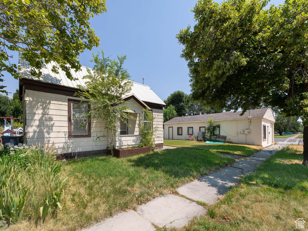 Rear view of property with a yard