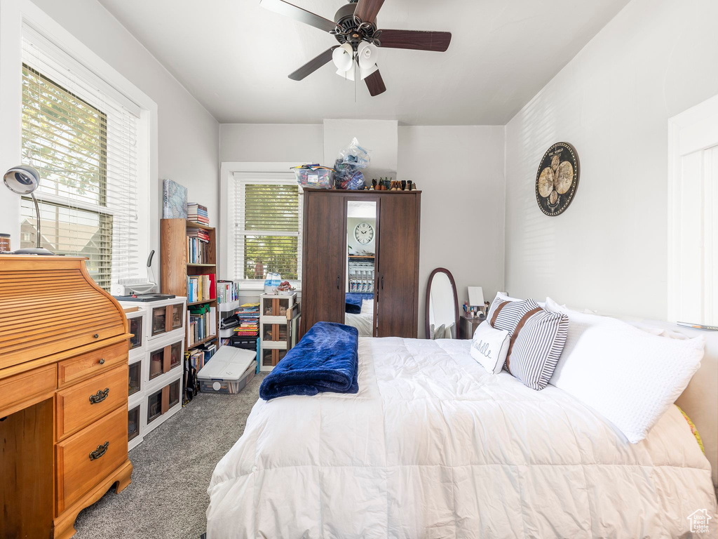 Carpeted bedroom with ceiling fan